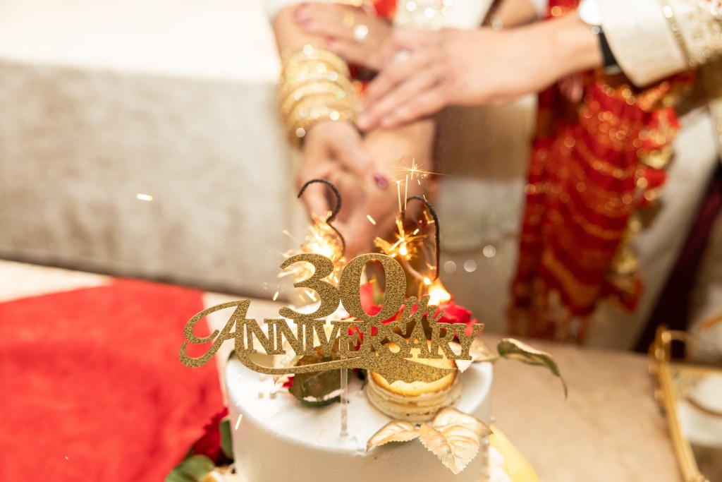 Close-up of a 30th anniversary cake-cutting celebration in Mississauga