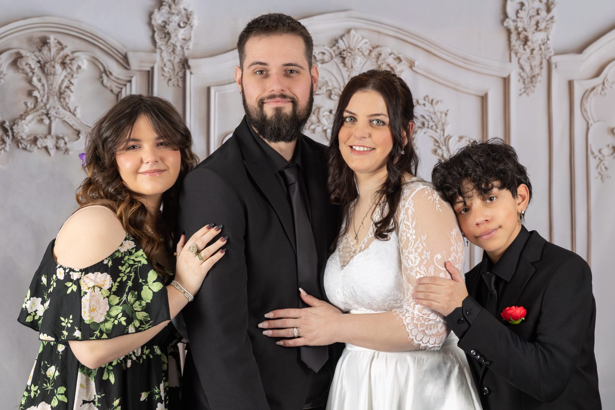 Parents and two children posing for a formal studio family portrait in Mississauga