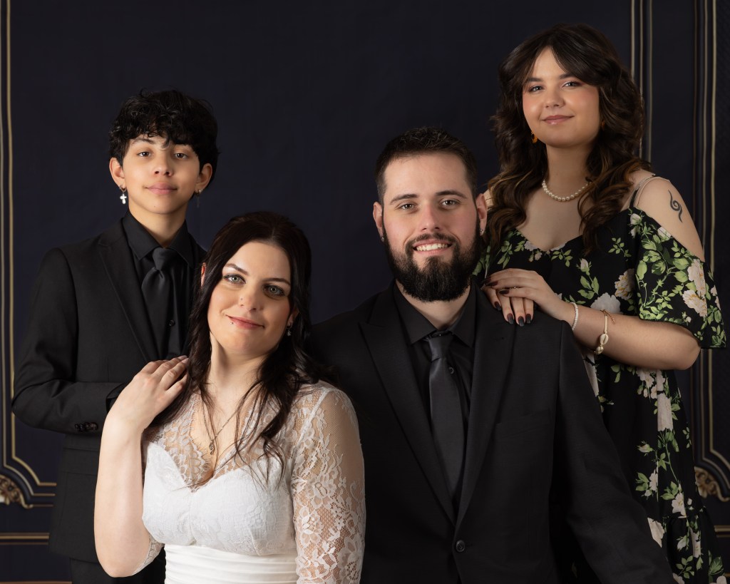Formal family portrait with elegant attire.