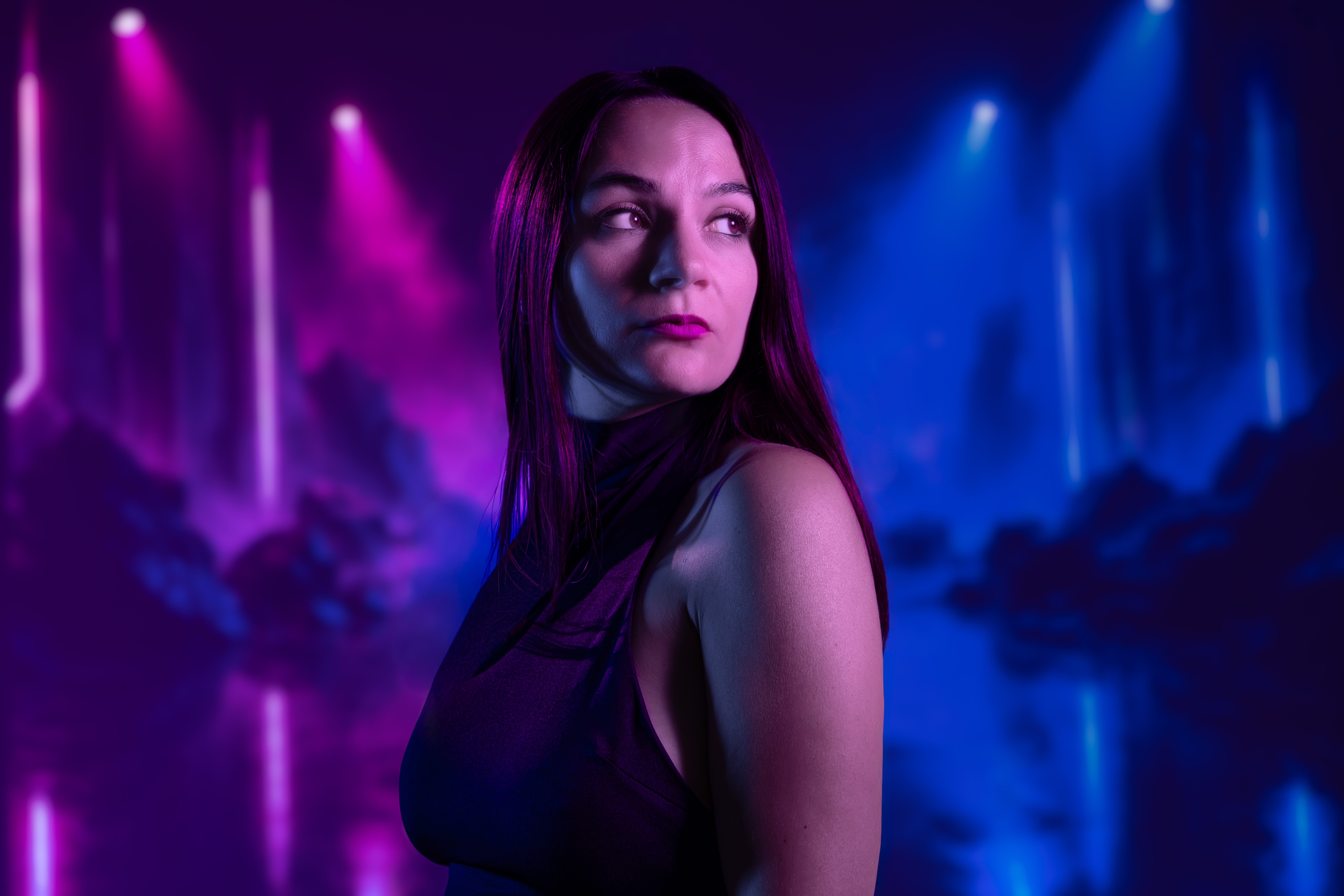 Creative studio portrait of a woman with purple and blue cinematic lighting in Mississauga