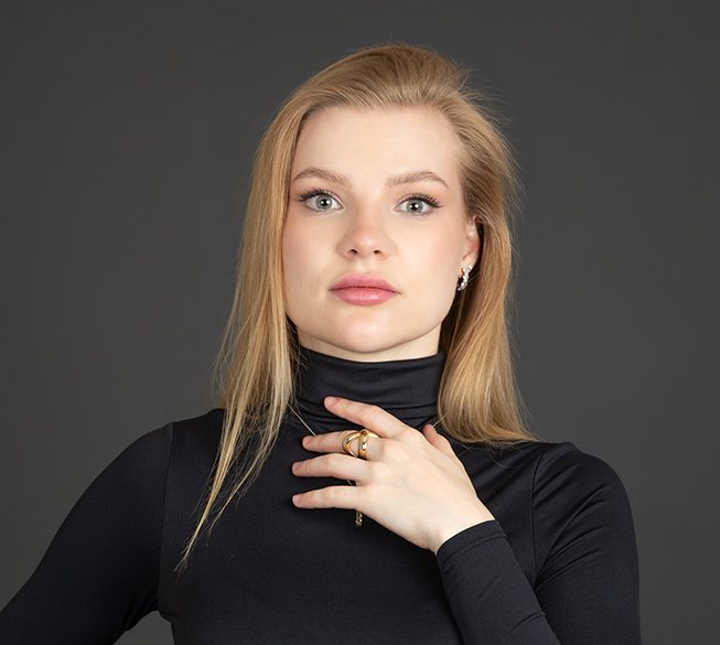Alt text: Professional headshot of a woman in black photographed in a Mississauga studio